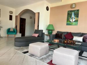 a living room with a couch and a table at Résidence Gabrielle in São Tomé