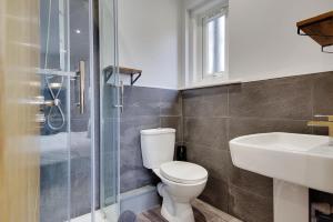 a bathroom with a toilet and a sink and a shower at Wimbourne Road Apartment 1 in Bournemouth