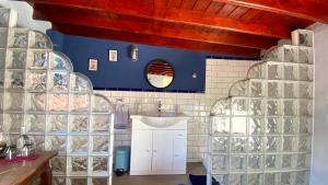 a bathroom with a sink and a mirror at Angel Caves Farmstay in Vega de San Mateo