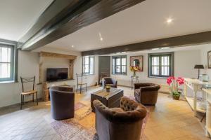 a large living room with couches and a tv at Ch&acirc;teau de Briante in Saint-Lager