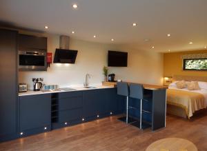 a kitchen with a sink and a bed in a room at The Lodges at Thornbrook in Ingleton 