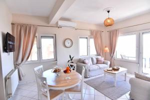 a living room with a table and a couch at Blue Memories in Kavala