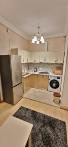 a kitchen with a refrigerator and a stove at 2 комнатная квартира в центре Еревана in Yerevan