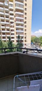 a bed on a balcony of a large building at 2 комнатная квартира в центре Еревана in Yerevan