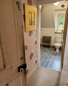 an open door to a bathroom with a toilet at Victorian Gate House Own Bathroom in Solihull