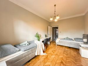 a living room with two beds and a desk at 3 - room Masaryk A 100m2 City Centrum Kosice in Košice