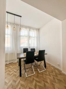 a dining room with a table and four chairs at 3 - room Masaryk A 100m2 City Centrum Kosice in Košice
