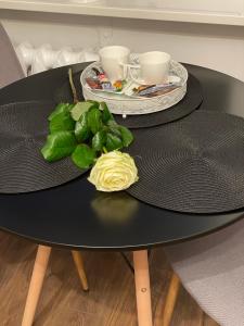 a black table with two plates of food on it at Harmony Apartament in Suwałki