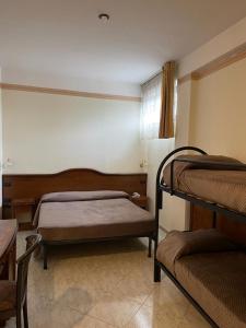 a bedroom with two bunk beds and a window at Il Castello in Terzigno