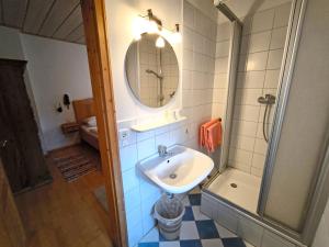 a bathroom with a sink and a shower and a mirror at Bauernhof Geigerhof in Aschau im Chiemgau +12 photos