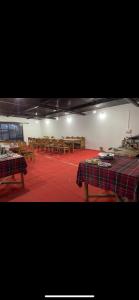 a room with tables and wooden benches in it at Nubra ethnic camp in Nubra