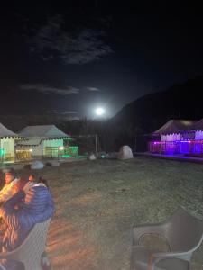 a group of people sleeping in a chair at night at Nubra ethnic camp in Nubra