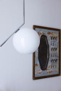 a light hanging from a ceiling with a picture at Boutique Apartment Cà Monastero in Verona
