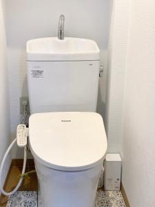 a bathroom with a white toilet and a sink at Spring Apartment Shinjuku in Tokyo