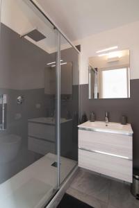 a bathroom with a sink and a toilet and a mirror at B&B Domus San Pietro in Cetara