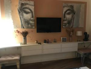 ポルティシオにあるVilla Pierre SANTONIのテレビと壁に2つの頭があるリビングルーム