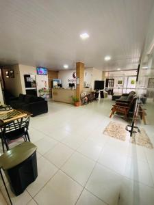 a large living room with a large white tile floor at Borges Hotel in Imperatriz