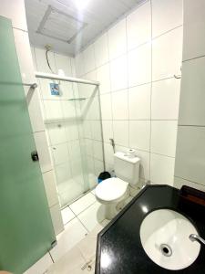 a bathroom with a toilet and a shower and a sink at Borges Hotel in Imperatriz