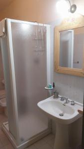 a bathroom with a shower and a sink and a mirror at Il Borghetto in Todi