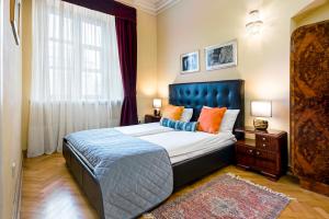 a bedroom with a large bed and a large window at Apartamenty Kamienica Muzyków Old Town Lublin in Lublin