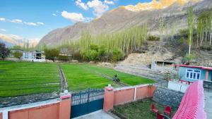 a view from the balcony of a house in the mountains at Vantage Lodge in Skardu +10 photos