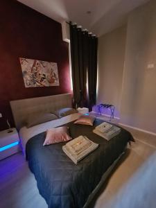 1 Schlafzimmer mit 2 Betten in einem Zimmer mit lila Lichtern in der Unterkunft Casa Beda in Bologna