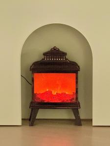 a fireplace with an orange fire inside of it at 사당 그린나래 스테이 in Seoul