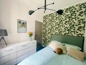 a bed with a teddy bear laying on top of it at Krystel Avel à La baule in La Baule