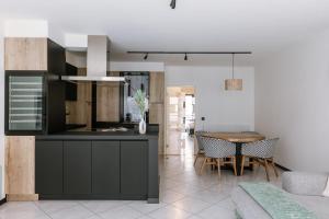 a kitchen and dining room with a table at Huswell - Stylish two bedroom apartment on top location in Middelkerke