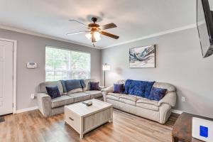 a living room with two couches and a ceiling fan at Baton Rouge Home with Yard about 14 Mi to Downtown! in Baton Rouge