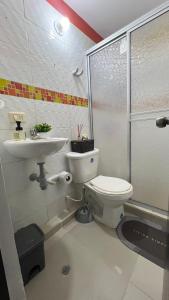 a bathroom with a toilet and a sink and a shower at Apartamento festival vallenato in Valledupar