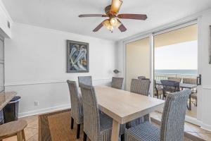 a dining room with a table and chairs and a ceiling fan at FL-Seaspray Perdido Key 605 condo in Pensacola