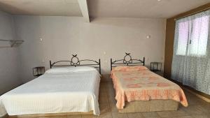 Postel nebo postele na pokoji v ubytování HOTEL XANTI