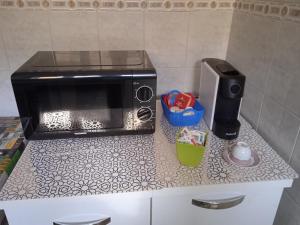 a microwave sitting on a counter in a kitchen at La casa di Lucia Appartamento in Novara