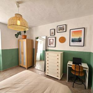 a bedroom with a bed and a dresser and a desk at Casa di Marco in Irola