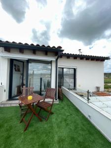 a patio with two chairs and a table on a roof at Habitaciones con encanto 