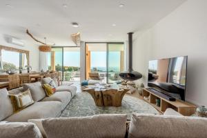 Villa Oceânica في ألبوفيرا: غرفة معيشة مع أريكة وتلفزيون