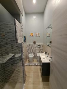 a bathroom with a shower and a sink and a toilet at Casa Beda in Bologna