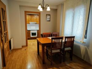 a kitchen and dining room with a table and chairs at Apart. Casa Juaneta Pirineo-Ordesa in Broto +7 photos