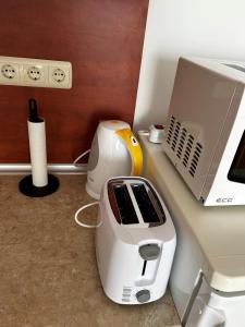 a sewing machine sitting on a counter next to a laptop at Peter Apartmanbulgaria-Imperial Fort Noks in Elenite