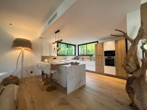 a kitchen with a white island in a room at Superbe Villa très proche cannes in Mougins