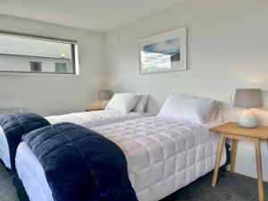 a living room with a bed and a couch at Aspiring View Apartments in Wanaka