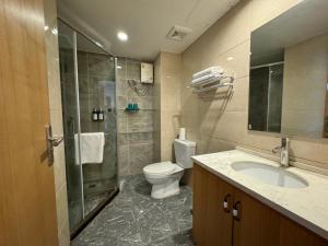 a bathroom with a toilet and a shower and a sink at Pentafield City Residence in Amphoe Phra Khanong +34 photos