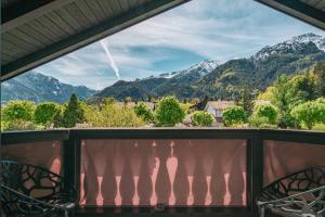 a view from a balcony with mountains in the background at Villa Sonnenhof Boutique-Hotel in Bad Reichenhall