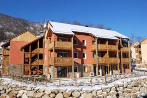 a large apartment building with snow on the roof at Grand studio à la montagne in Ax-les-Thermes