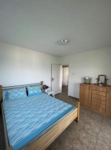 a bedroom with a bed and a dresser at The Original Zukovica Home in Kotor