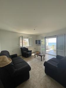 a living room with two couches and a table at The Original Zukovica Home in Kotor