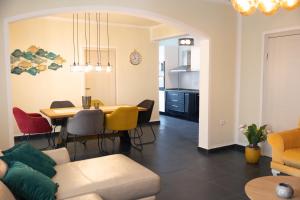 a living room and dining room with a table and chairs at Apartmani Novkovic in Bar