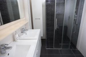 a bathroom with a sink and a shower at Apartmani Novkovic in Bar +49 photos