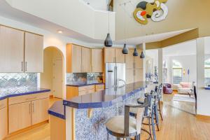 a kitchen with a blue counter top and chairs at Spacious Missouri Retreat with Pool, Gym and Game Room in Chesterfield